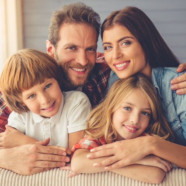 Family of four smiling